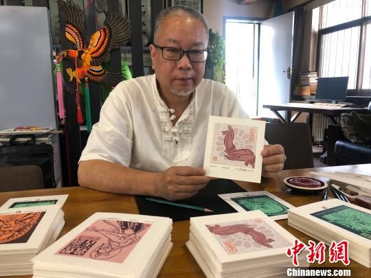圖為徐晉林展示藏書票。　徐雪 攝