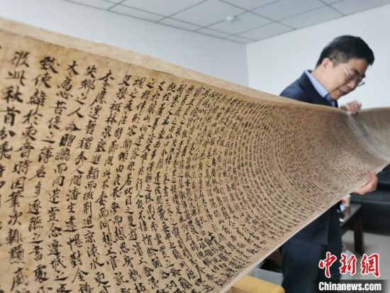 2020年9月底，讀者集團敦煌文藝出版社社長展示《敦煌法藏文獻》的復制品。(資料圖) 閆姣 攝