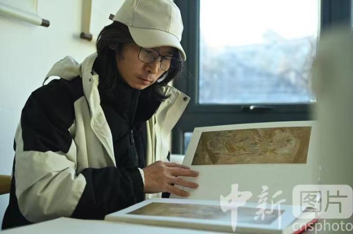 1月3日，在甘肅蘭州創(chuàng)意文化產(chǎn)業(yè)園內(nèi)，季茂杰研究敦煌文化相關(guān)書籍。